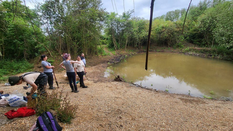 People next to a pond