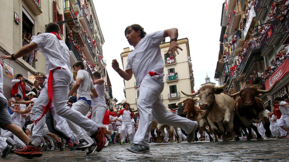Runners flee from bulls during the San Fermín festival in Pamplona July 2018