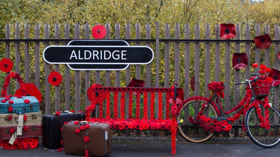A sign in Station Road, Aldridge in Walsall which has transformed itself into Poppy Road as almost 100 houses have been decorated with 24,000 red poppies and silhouette statues of soldiers to honour local people