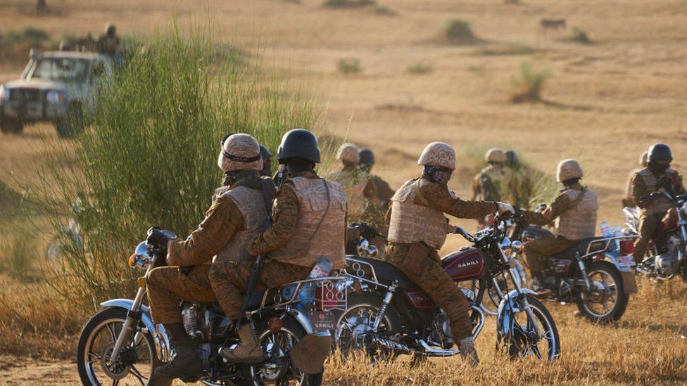A radical  of soldiers of the Burkina Faso Army patrols a agrarian  country  during a associated  cognition  with the French Army successful  the Soum portion   successful  bluish   Burkina Faso connected  November 10, 2019.