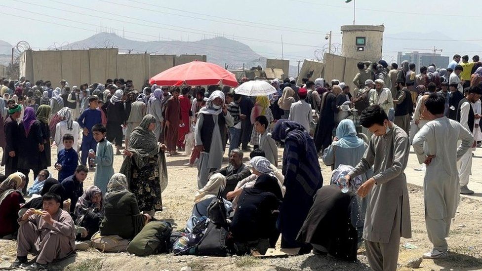 People wait outside Hamid Karzai International Airport in Kabul, Afghanistan on 17 August 2021