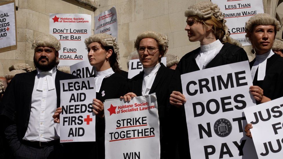 Barristers gathered outside the Royal Courts of Justice in London