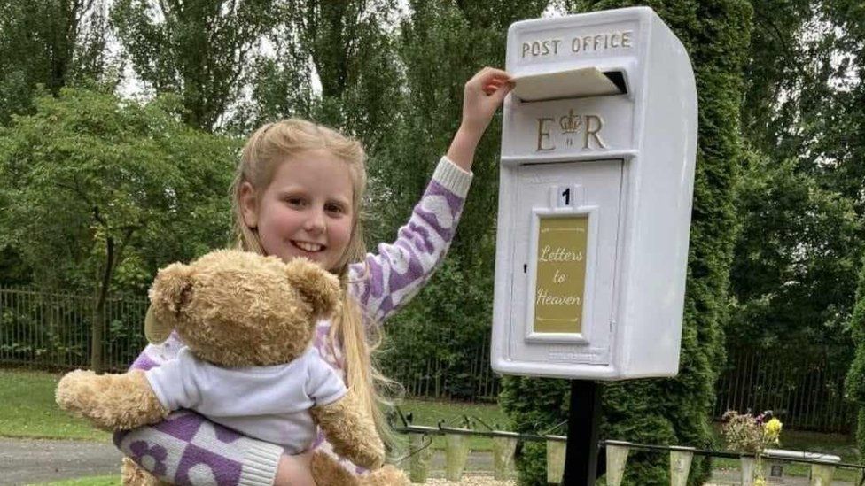 Polly, nine, posts first letter 'letters to heaven' box