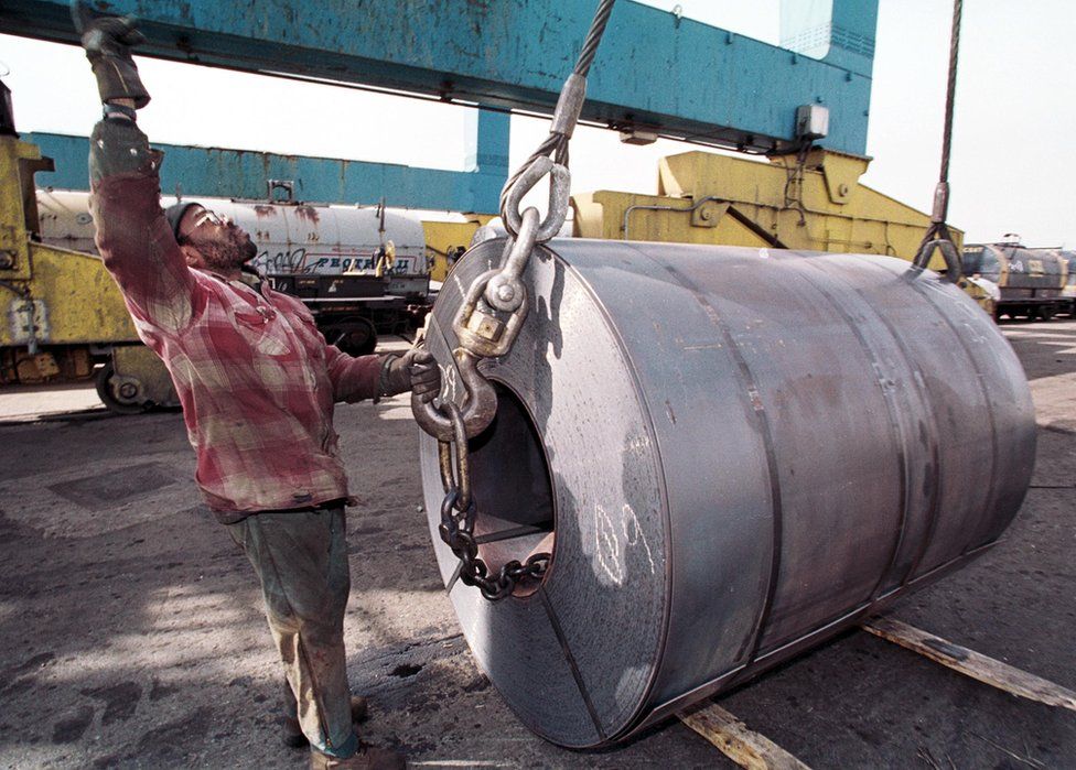 An employee of the South Jersey Port Corporation in Camden NJ with a coil of imported steel