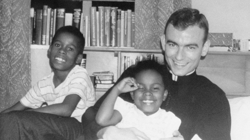 Jonathan Daniels with two African American children visiting him at his seminary