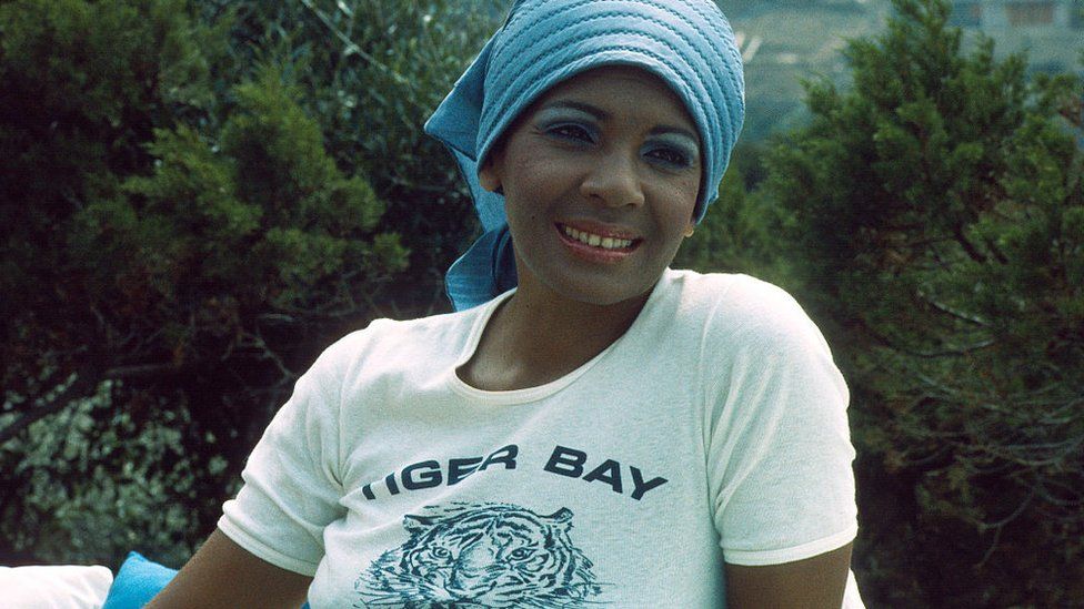 Shirley Bassey relaxes on holiday by the sea circa 1970s