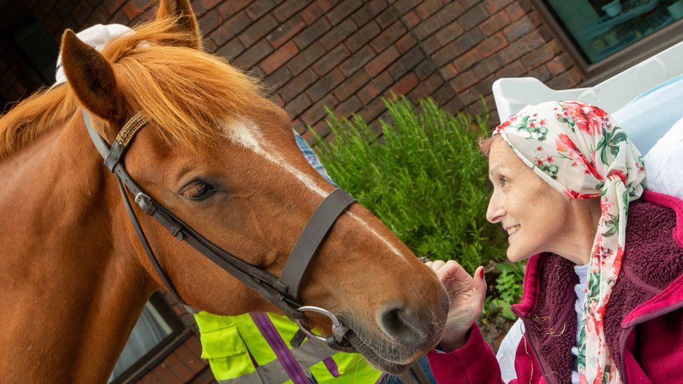Hayley Golding with a horse outside a hospice in Aylesbury