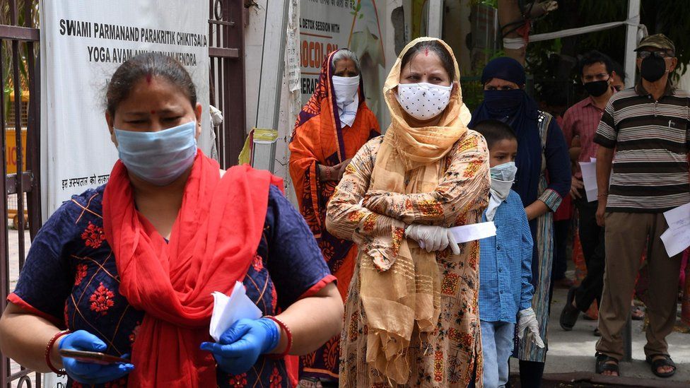 People with coronavirus symptoms wait in queue for a COVID-19 test at an ayurvedic hospital during a lockdown imposed as a preventive measure against the spread of the COVID-19 coronavirus in New Delhi on May 29, 2020.