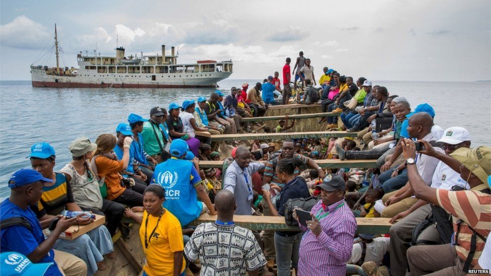 Refugees from Burundi who fled the ongoing violence and political tension and aid workers sail on a boat to reach MV Liemba, a ship freighted by the United Nations at the Kagunga landing base on the shores of Lake Tanganyika near Kigoma in Tanzania