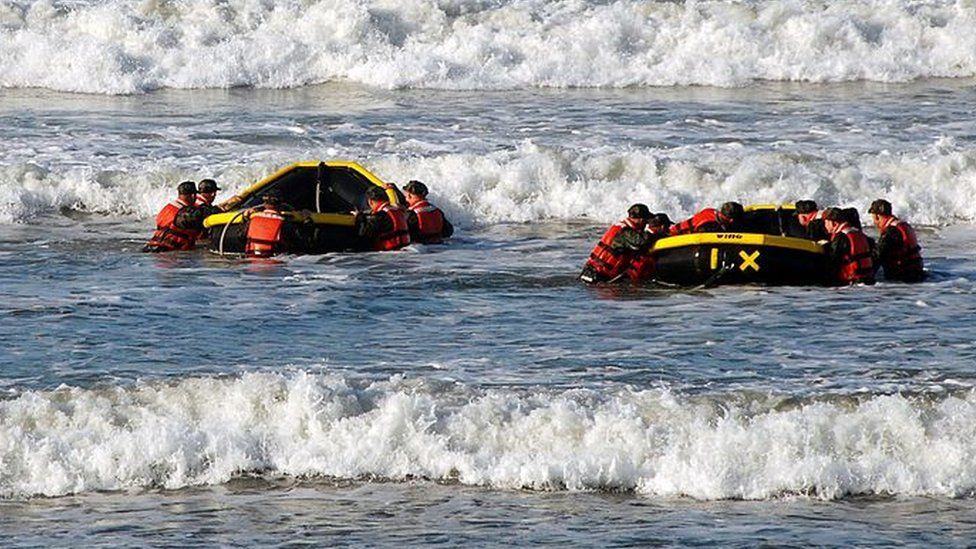 Students from Basic Underwater Demolition/SEAL (BUD/S) class 286 participate in a surf passage training exercise at Naval Amphibious Base Coronado October 27, 2010