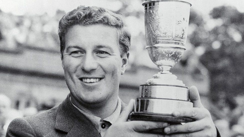 Peter Thomson holds his third Open Championship trophy in 1956