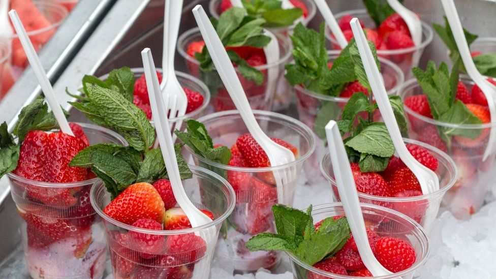 Single-use plastic forks in strawberry cups