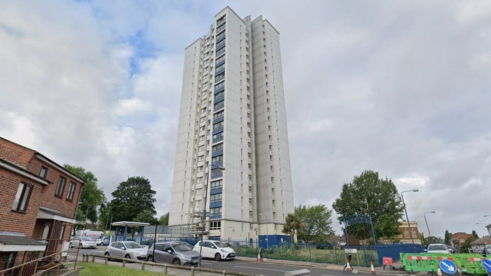 Image of the 20-storey grey and blue tower block where one of Mr Jones' flats is
