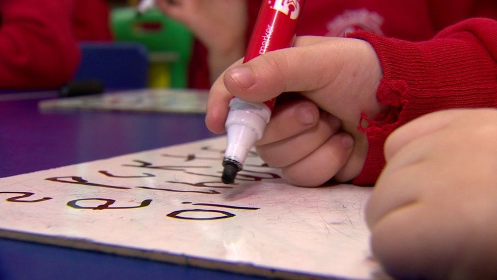 A child writing with a marker