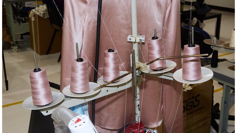Pink sewing thread on a machine