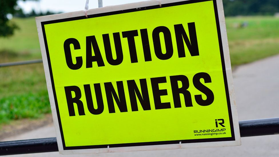 Sign reads: "Caution Runners"