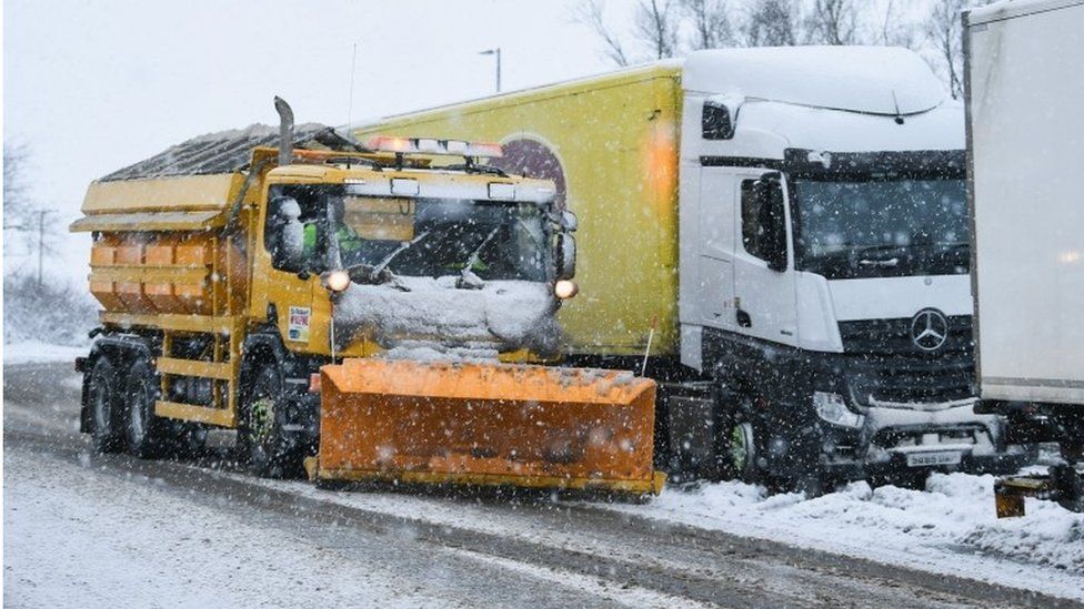 A snow plough clears snow on a slip road next to the M74 following motorist spending the night stranded on the motorway on January 17, 2018 in Abington, Scotland