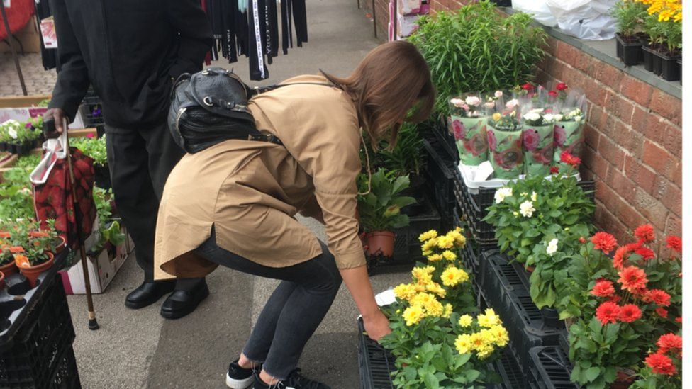 Woman buying flowers