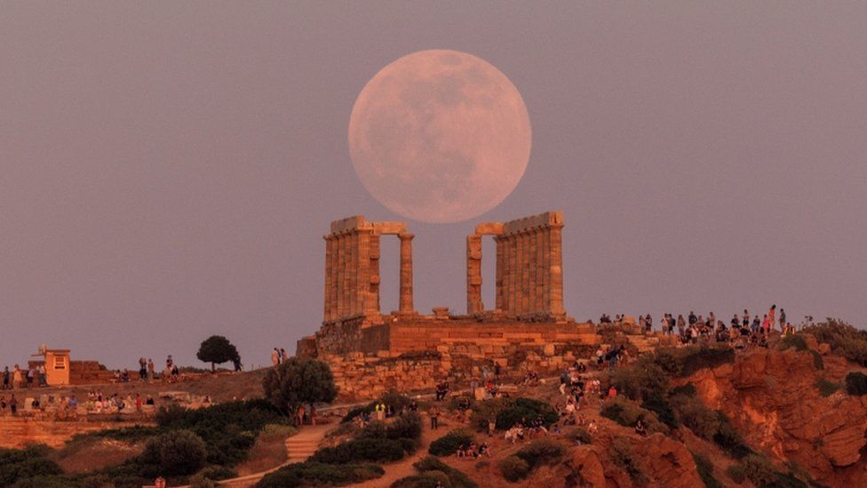 Image shows super moon above Temple of Poseidon