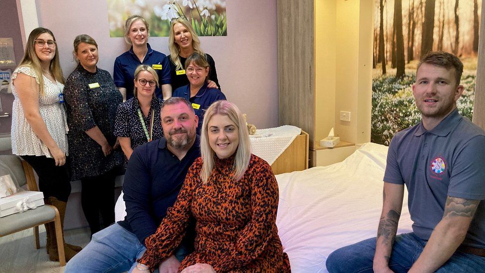 The Browns and hospital staff in a revamped room