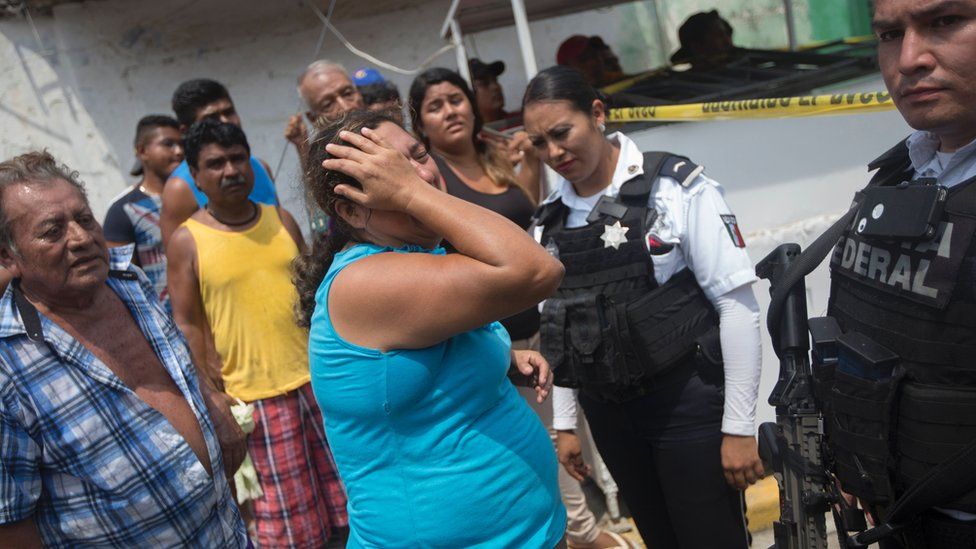 Relatives of five people murdered on a street cry in Acapulco's Icacos neighborhood, Guerrero State, Mexico, on April 17, 2016.