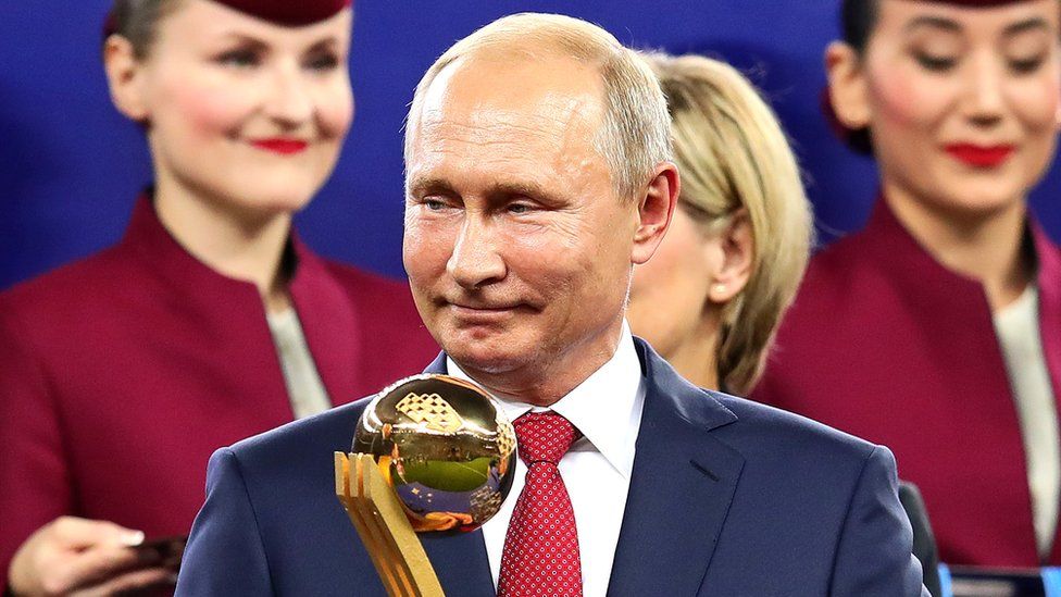 President of Russia Vladimir Putin looks on holding the player of the tournament award after the 2018 FIFA World Cup Russia Final on 15 July 2018