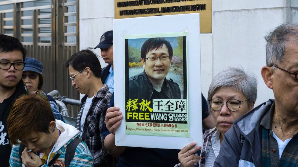 Activists hold a placard of detained Chinese human rights lawyer Wang Quanzhang at a rally outside Chinese Liaison Office in Hong Kong on December 26, 2018