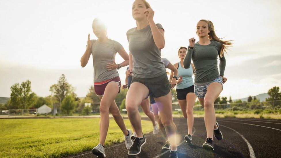 Girls running round a track