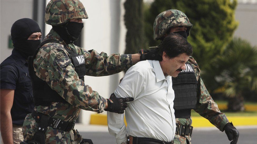 Joaquin 'El Chapo' Guzman is escorted to a helicopter in handcuffs by Mexican navy marines at a navy hanger. Guzman leader of Mexico's Sinaloa drug Cartel, was captured alive overnight in the beach resort town of Mazatlan, considered the Mexican most-wanted drug dealer on February 22, 2014 in Mexico City, Mexico.