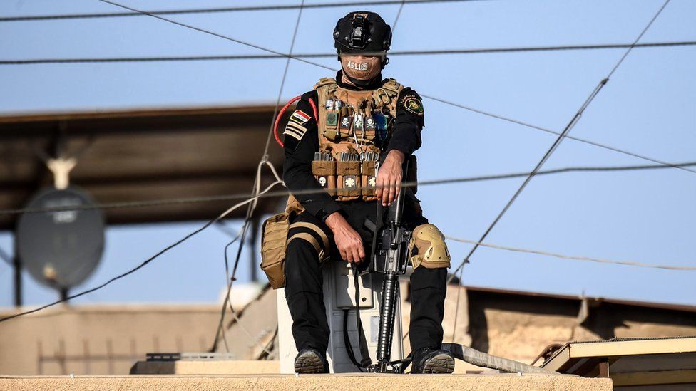 A member of the Iraqi special operations forces on guard near Baghdad's Saint Joseph Cathedral ahead of a mass celebrated by Pope Francis, 6 March 2021