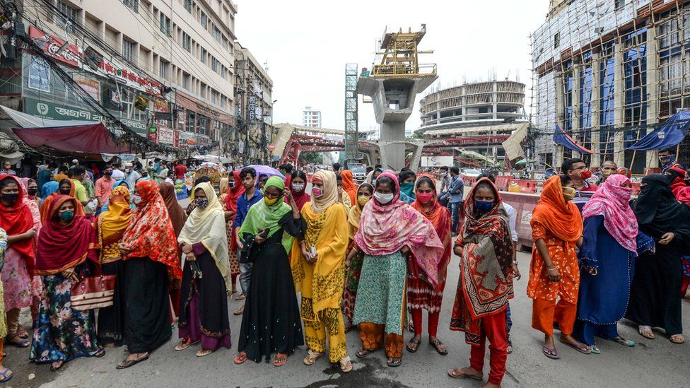Workers from the garment sector block a road as they protest to demand the payment of due wages during a government-imposed nationwide lockdown as a preventive measure against the Covid-19 in Dhaka on 22 April 22 2020