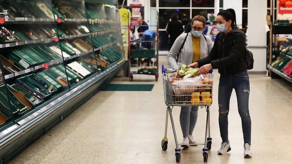 Shoppers are seen inside a Tesco store wearing face masks while shopping in a supermarket on March 18, 2020 in Southampton, United Kingdom.