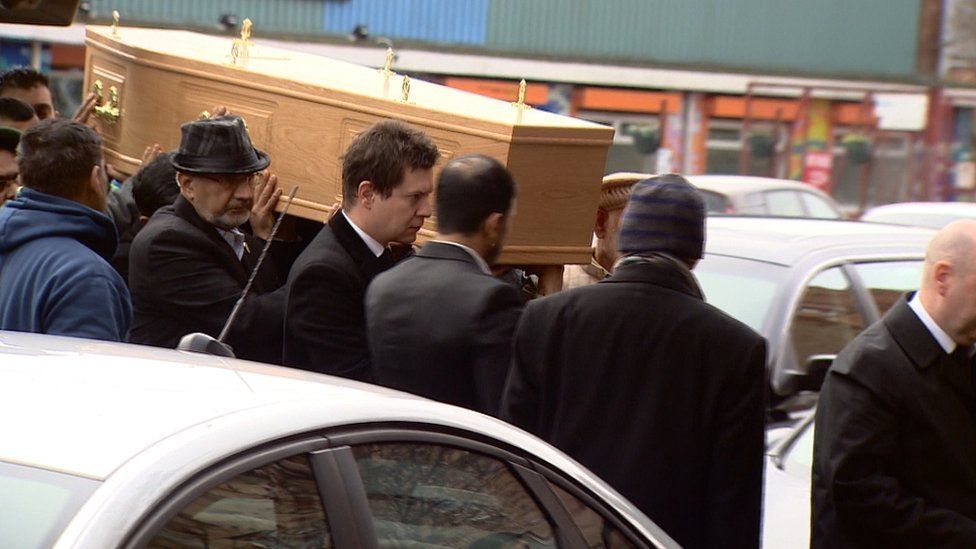 Coffin being carried into mosque
