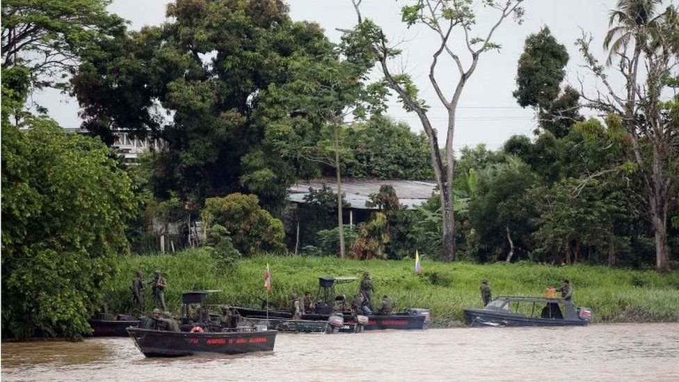 Venezuelan soldiers patrol by boat on the Arauca River, the border between Colombia and Venezuela, as seen from Arauquita, Colombia March 28, 2021.