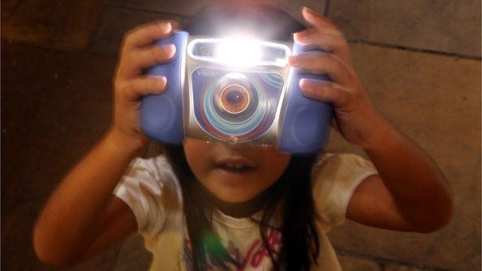 A girl plays with the Kidizoom Multimedia Digital Camera made by V-Tech