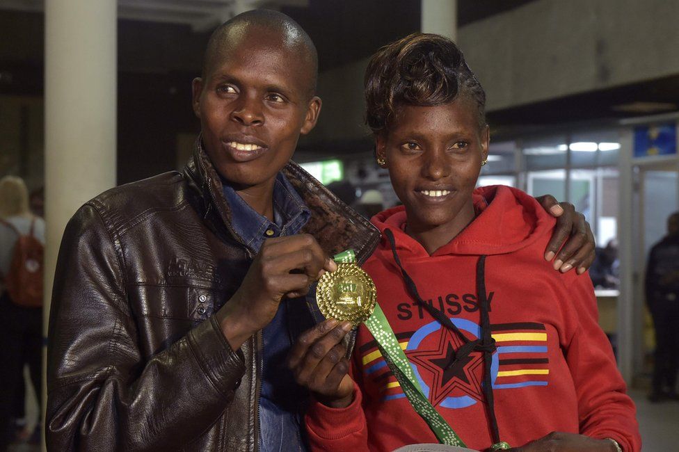 Kenya's Paul Lonyangata and wife Purity Rionoripo pose on Monday in Nairobi with one the gold medals they won at the Paris marathon. Photo/AFP