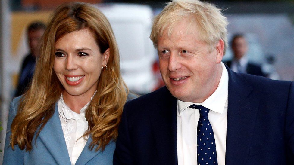 Prime Minister Boris Johnson and his girlfriend Carrie Symonds arrive at a hotel ahead of the Conservative Party annual conference in Manchester, Britain,