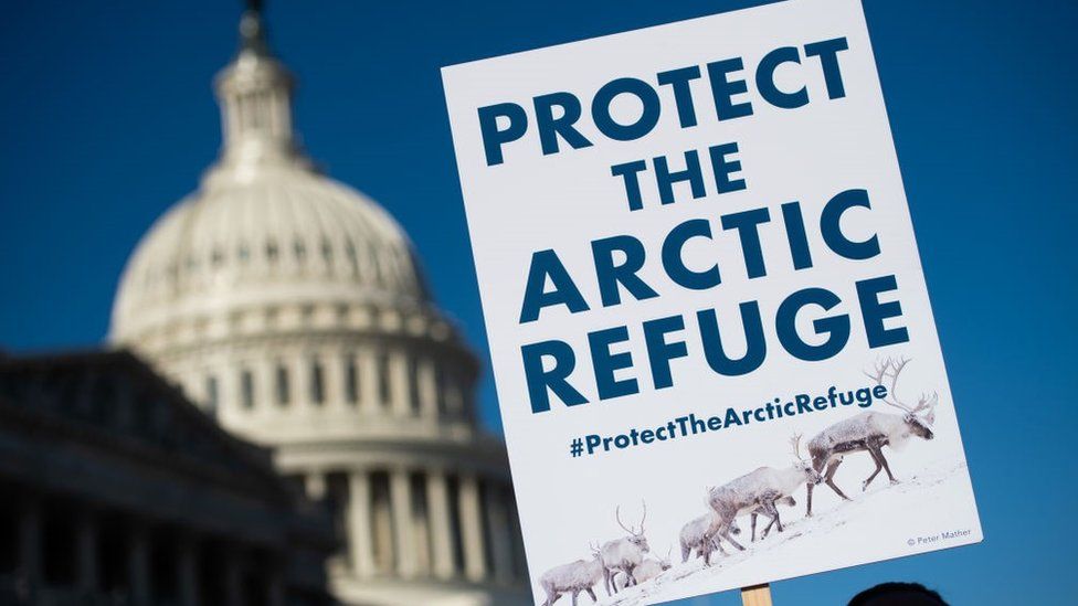 A demonstrator holds a sign against drilling in the Arctic Refuge on the 58th anniversary of the Arctic National Wildlife Refuge, during a press conference outside the US Capitol in Washington, DC, December 11, 2018.