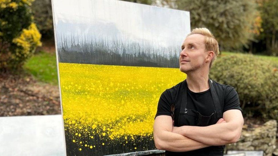 Ian in front of one of his paintings