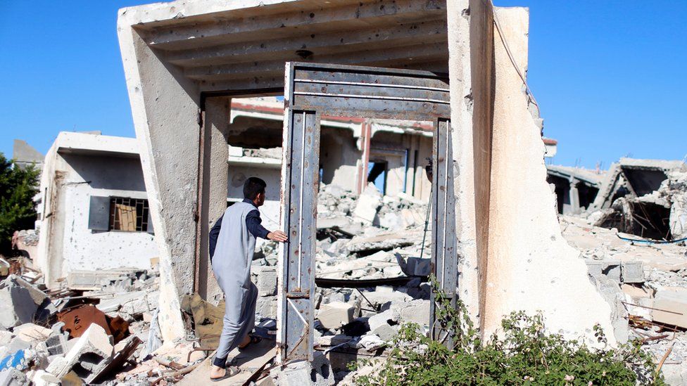 A man walks through the derbris of a house that was destroyed during clashes between Libyan forces and Islamic State militants in Sirte, Libya, November 1, 2017