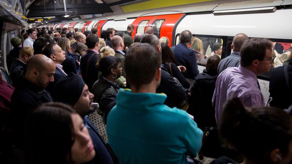 Commuters travel on the Northern Line of the London Underground