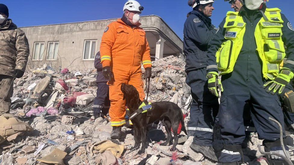 Kyle and Delta on search duty on a rubble pile