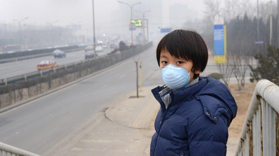 Boy in mask in smog in Bejiing