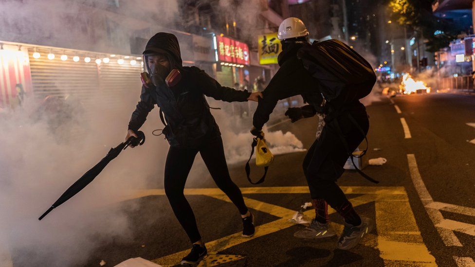 Pro-democracy protesters react as police fire teargas during a demonstration in Wan Chai district on November 2, 2019 in Hong Kong, China.