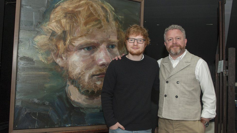 Ed Sheeran and Colin Davidson stand beside the portrait