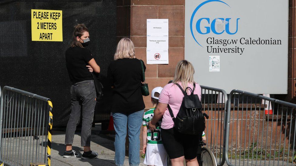 Members of the public queue outside the new walk-through testing centre as it opened today at Glasgow Caledonian University's ARC sports centre on September 18, 2020 in Glasgow