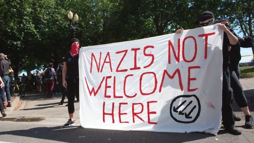 Antifa protestors with a "Nazis not welcome here" sign