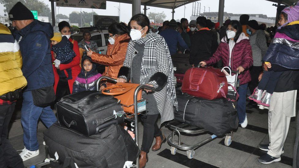 Passengers arriving from Italy after exist the arrival section of the airport post their Covid-19 coronavirus screening at Sri Guru Ram Dass Jee International Airport on January 6, 2022 in Amritsar, India.