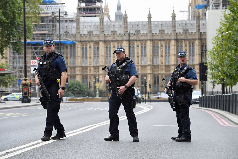 Armed police on Victoria Embankment in Westminster, central London, after a car crashed into security barriers outside the Houses of Parliament.