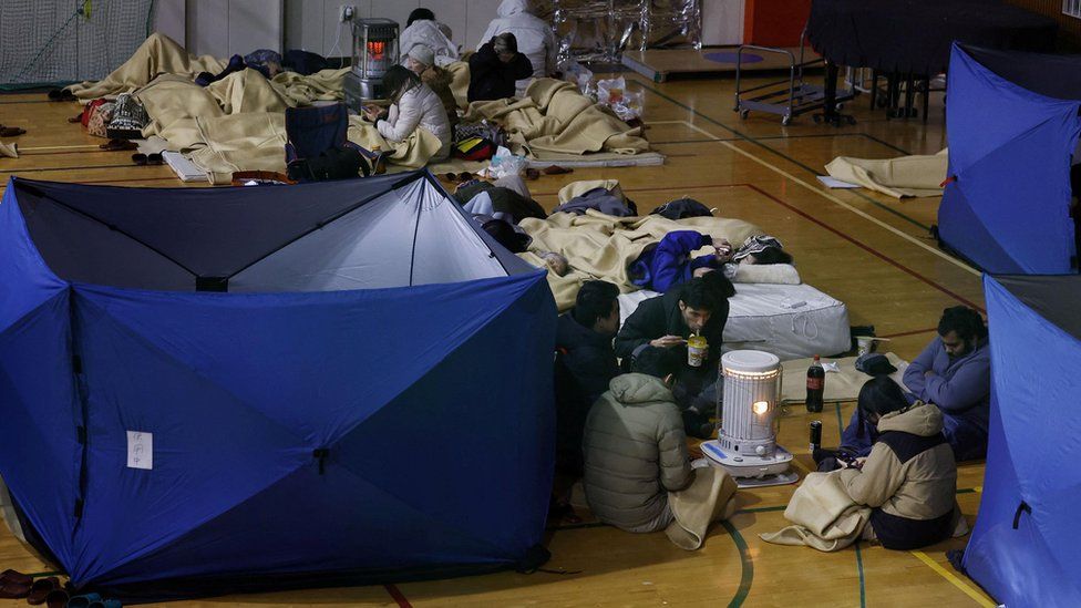 Local residents rest at an elementary school acting as an evacuation shelter after an earthquake hit central Japan